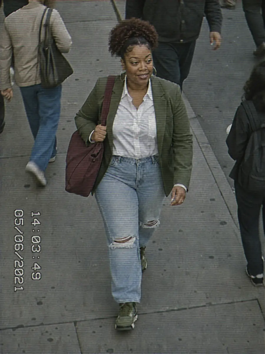 Surveillance still of Shené walking a city sidewalk